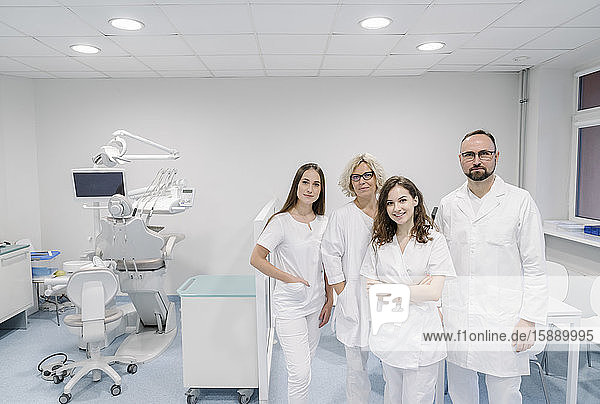 Group of dentists standing in clinic