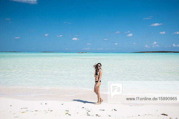 Woman walking on white sand bank in the sea  Bahamas  Carribean