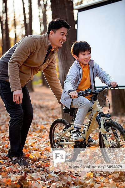 Happy father's taught him to ride a bicycle