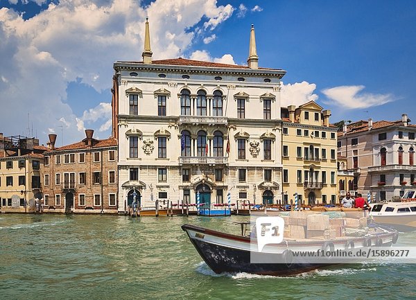 Venice Venice Province Veneto Italy. Boat transporting goods on the Grand Canal.