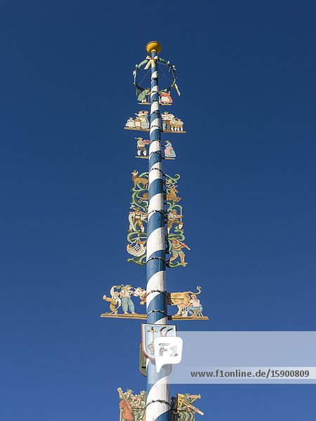 Traditional bavarian maypole (Maibaum). Village Schliersee in the bavarian Alps. Europe Central Europe Bavaria Germany.