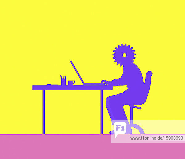 Mann mit Zahnradkopf bei der Arbeit am Computer