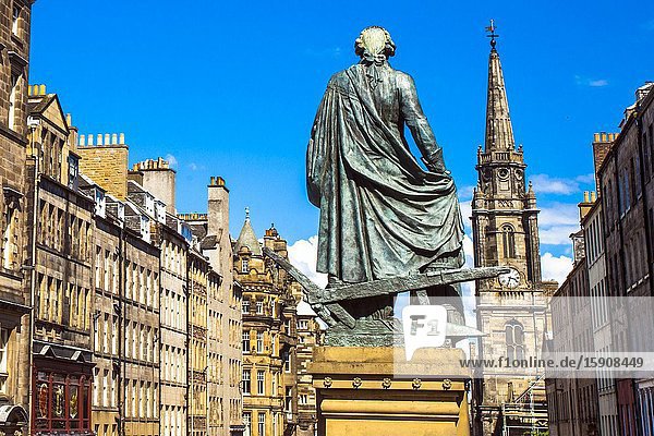 Adam Smith Statue The Tron Kirk church on background Royal Mile High Street Old Town Edinburgh Scotland United Kingdom Europe.