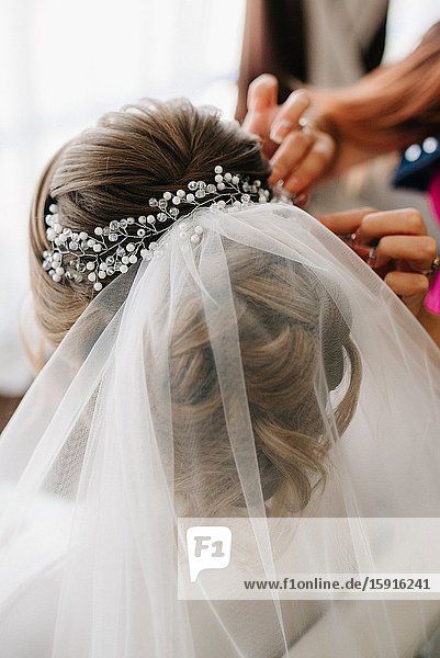 Bride hair back  twisted twisted curls with flowers.