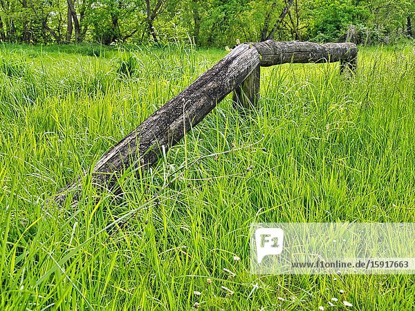 Broken wooden fence in long grass Lauzun Lot-et-Garonne Department Nouvelle Aquitaine France.