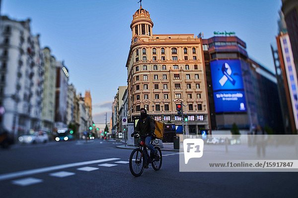 A biker at Callao Square and Gran Via Street during the confinement due to the national emergency caused by Covid-19 on April 12 2020 in Madrid Spain.The day before workers on Spain they return theirs non-essential works