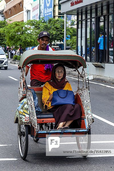 A Local Woman Travelling By Becak (Bicycle Rickshaw)  Yogyakarta  Indonesia.
