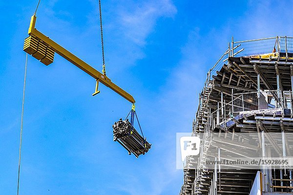 Crane hoiting up construction material at a construction site at Strijp-S Eindhoven The Netherlands.