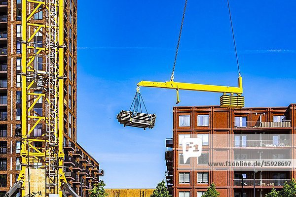 Crane hoiting up construction material at a construction site at Strijp-S Eindhoven The Netherlands.