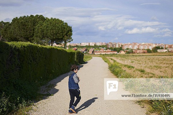 Young boy with a mask play in the field after 45 days at home without being able to leave as a measure of confinement for the Covid-19 on April 27 2020 in Madrid Spain.Young boy in Spain which has had one of the stricter lockdowns in Europe are now allowed to leave their homes for up to an hour per day. The country has had more than 220 000 confirmed cases of COVID-19 and over 20 000 reported deaths although the rate has declined after weeks of quarantine measures