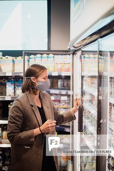 Woman with mask in supermarket.