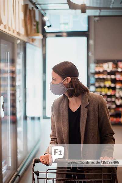 Woman with mask in supermarket.