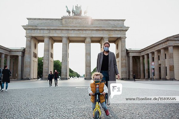 Mother and son walking in Brandenburg gate in Berlin in Corona days.
