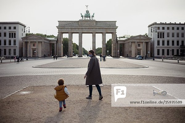 Mother and son walking in Brandenburg gate in Berlin in Corona days.