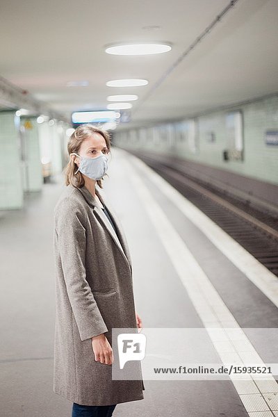 Woman using public transportation with mask during Corona days.