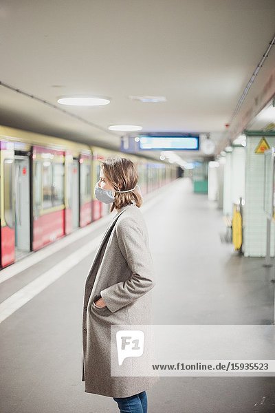 Woman using public transportation with mask during Corona days.