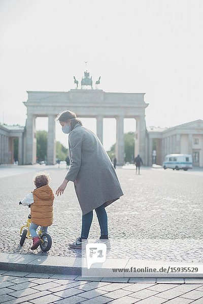 Mother and son walking in Brandenburg gate in Berlin in Corona days.