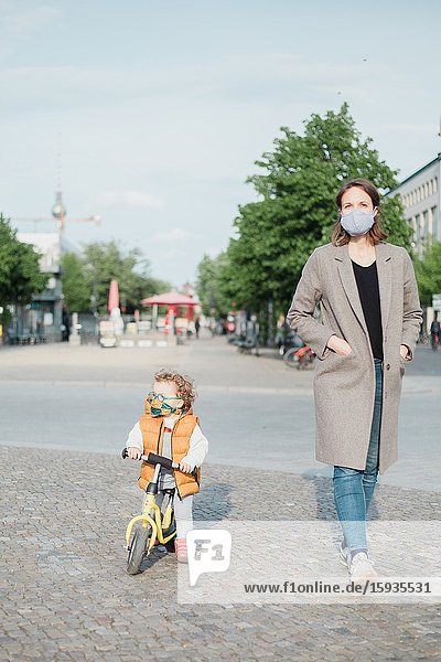 Mother and son walking in Berlin in Corona days.