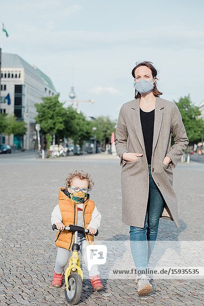 Mother and son walking in Berlin in Corona days.