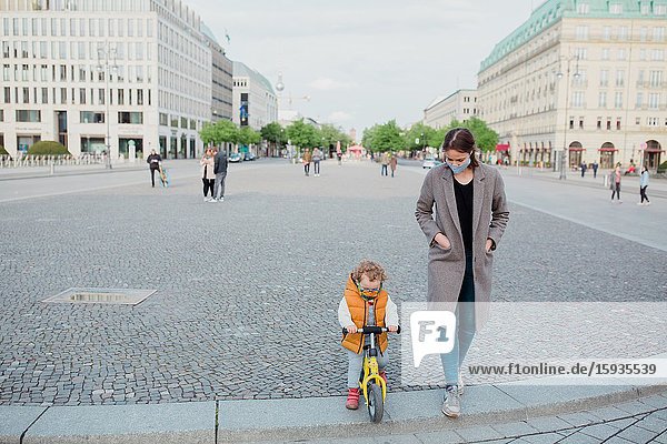 Mother and son walking in Berlin in Corona days.