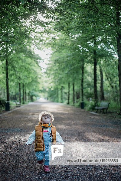 Little boy 2-3 Years old wih mask in the park.