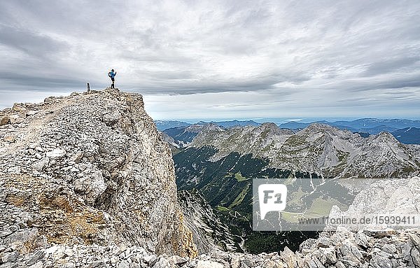 Hiker at the summit of the eastern Ödkarspitze  view of the Karwendel valley  Hinterautal-Vomper chain  Karwendel  Tyrol  Austria  Europe