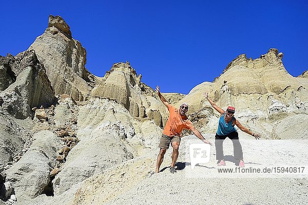 Two tourists at the bizarre rock formations of Cerro Alcázar  Calingasta  San Juan Province  Argentina  South America