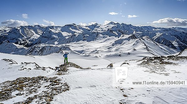 Man  ski tourer looks over snow-covered mountain ranges  ski tour  mountain panorama  view from Geierjoch to Olperer and Zillertaler Alps  Wattentaler Lizum  Tuxer Alps  Tyrol  Austria  Europe
