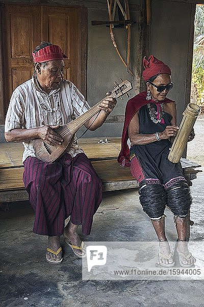 Music-making couple in the music house  Kayah tribe  Hta Nee La Leh village  Kayah state  Myanmar  Asia