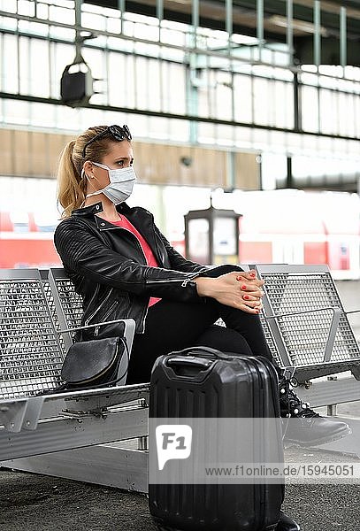 Woman with face mask  waiting for train  corona crisis  main station  Stuttgart  Baden-Württemberg  Germany  Europe
