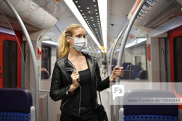 Woman with face mask  standing in suburban train  corona crisis  Stuttgart  Baden-Württemberg  Germany  Europe