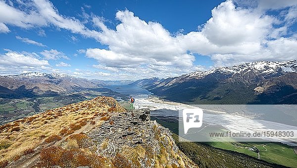 Hiker on the summit of Mount Alfred  views of Lake Wakatipu and mountain scenery  Glenorchy near Queenstown  Southern Alps  Otago  South Island  New Zealand  Oceania