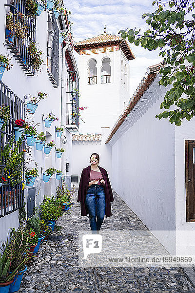 Frau geht in einer Gasse in Albaicin  Granada  Spanien