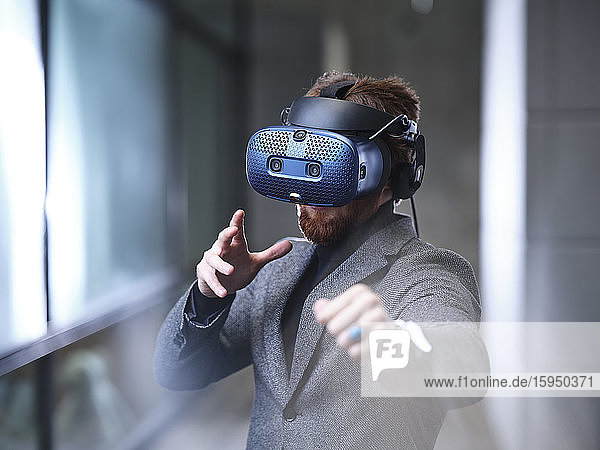 Man wearing VR glasses and headset in modern office