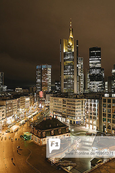 Germany  Hesse  Frankfurt  Illuminated town square at night with downtown skyscrapers in background