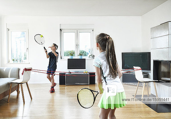 Brother and sister playing tennis at home during quarantine