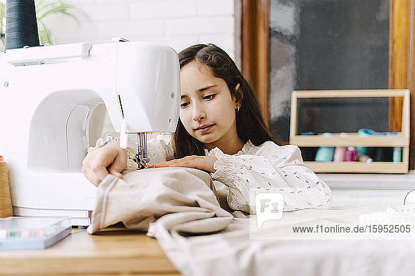 Girl sewing at home