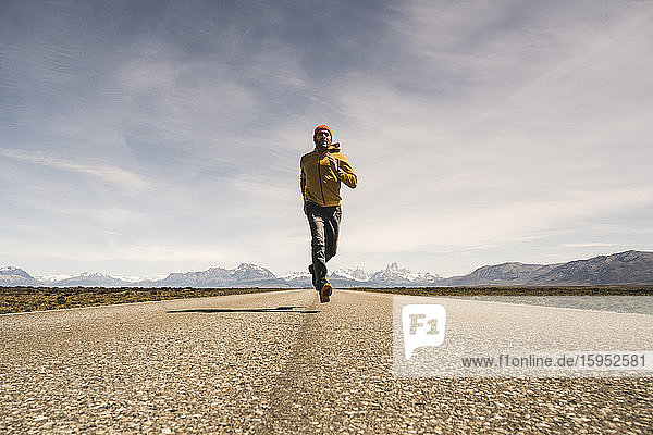Man running on a road in remote landscape in Patagonia  Argentina