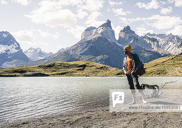 Happy man in mountainscape at lakeside in Torres del Paine National Park  Patagonia  Chile