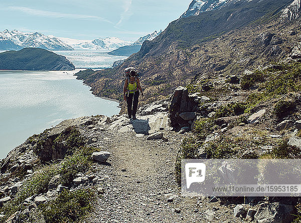 Woman with her backpack doing a mountain trekking  Parque Nacional Torres del Paine  Chile