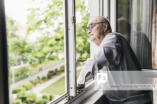 Senior man looking out of window