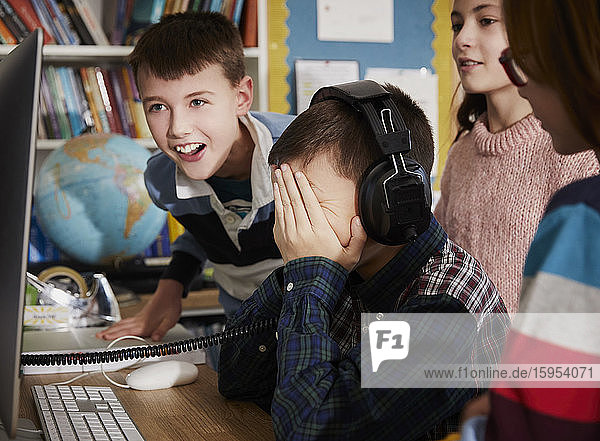 Children playing on a computer in classroom