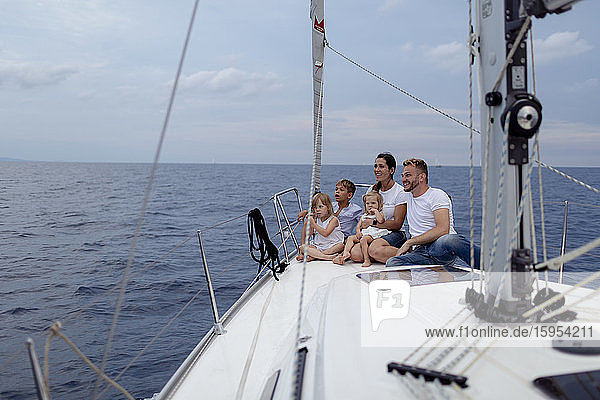 Family sitting on deck during sailing trip