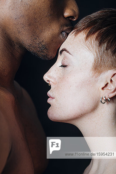 Studio portrait of affectionate mixed race couple