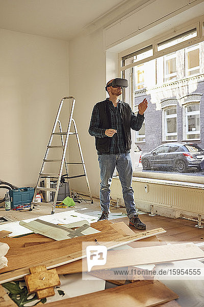 Man refurbishing shop location  using VR glasses
