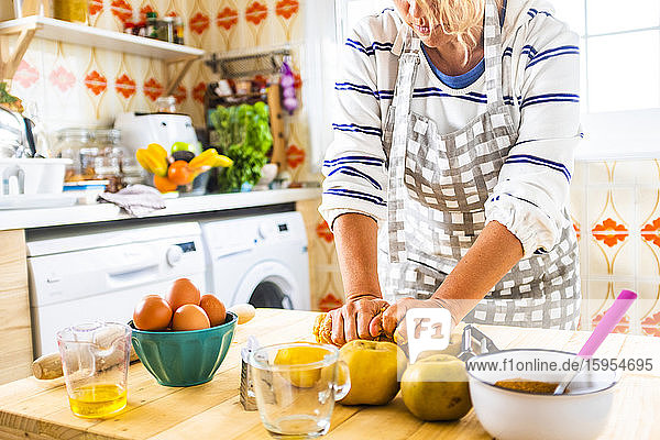 Woman preparing a cake in her kitchen