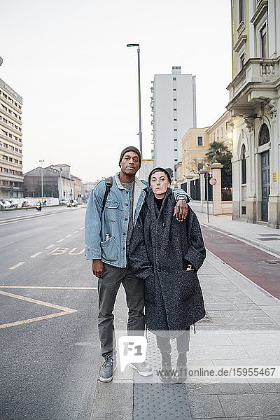 Young couple standing at the roadside in the city  Milan  Italy
