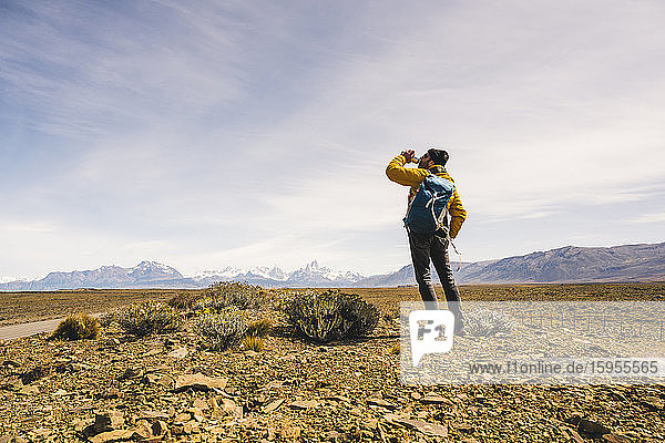 Hiker drinking from bottle in remote landscape in Patagonia  Argentina
