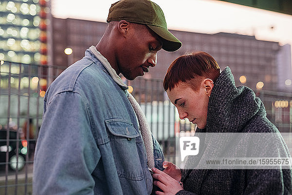 Young couple with cell phone in the city