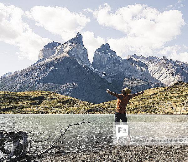 Hiker in mountainscape at lakeside in Torres del Paine National Park  Patagonia  Chile